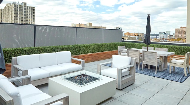 2773 N Hampden Ct Unit Ph03, Chicago, IL 60614 - view of patio / terrace with an outdoor living space with a fire pit, a view of city, and outdoor dining space