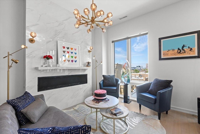 2773 N Hampden Ct Unit Ph03, Chicago, IL 60614 - living area with a fireplace, a chandelier, and wood finished floors