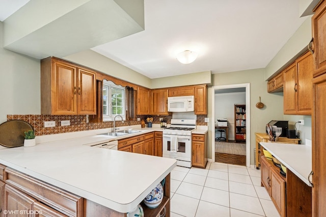 kitchen featuring white appliances, a peninsula, tasteful backsplash, light tile patterned floors, and light countertops