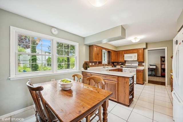 dining area featuring light tile patterned floors and baseboards