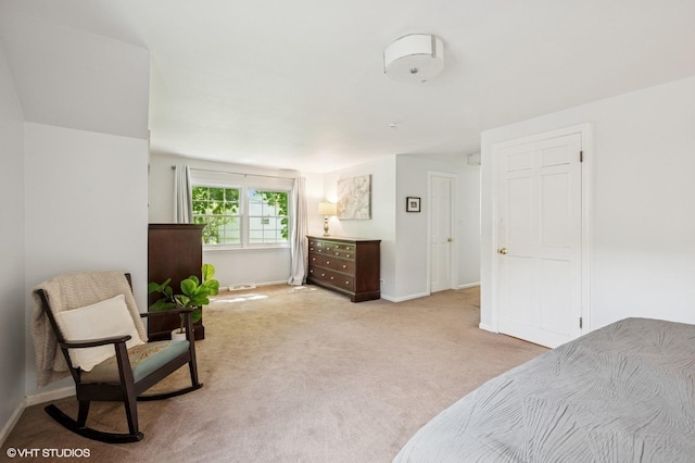 bedroom featuring light carpet and baseboards