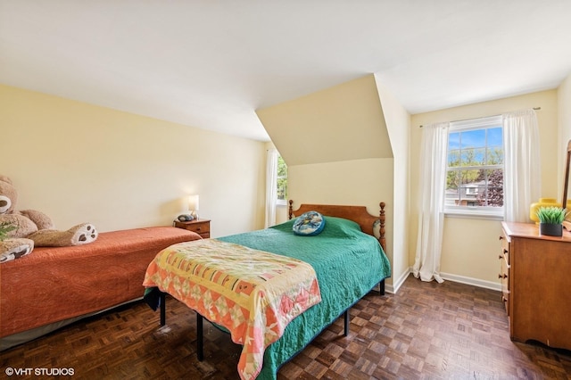 bedroom with multiple windows and baseboards