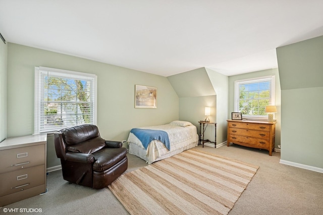 bedroom with light carpet and baseboards