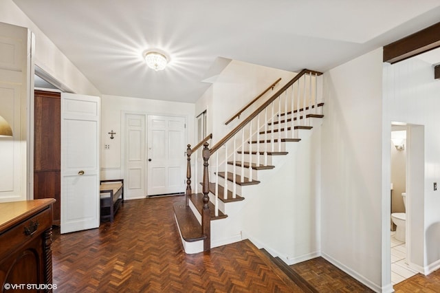 foyer with stairway and baseboards