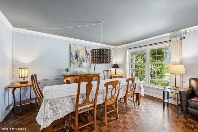 dining room with crown molding and baseboards