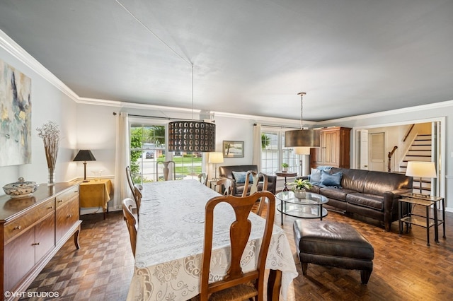 dining room with crown molding, plenty of natural light, and stairs