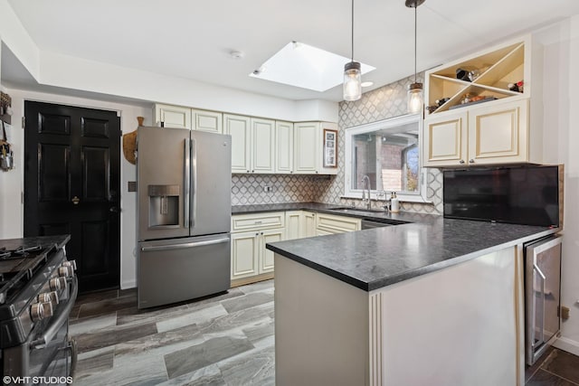3300 Overland Pass, Northbrook, IL 60062 - kitchen with appliances with stainless steel finishes, cream cabinetry, dark countertops, a sink, and a skylight