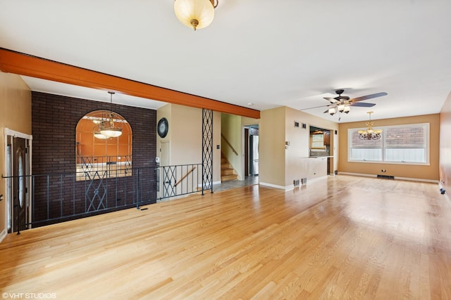 1826 Coolidge Ave, Berkeley, IL 60163 - unfurnished living room featuring a chandelier, ceiling fan, wood finished floors, stairway, and baseboards