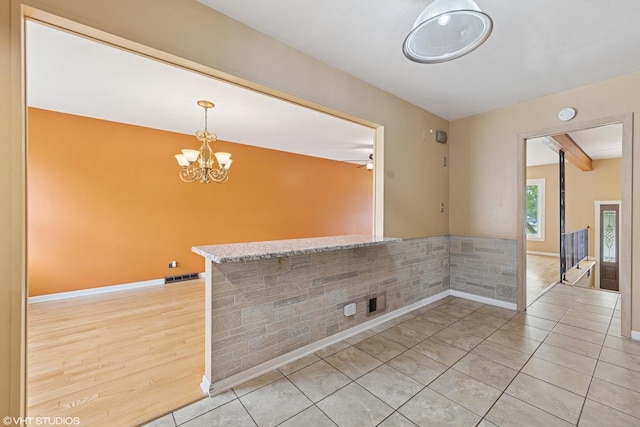 1826 Coolidge Ave, Berkeley, IL 60163 - unfurnished dining area featuring a chandelier, light tile patterned floors, and baseboards