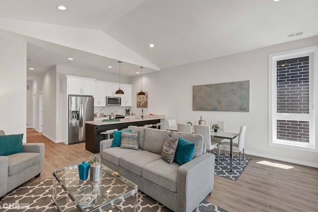 5201 S Wabash Ave, Chicago, IL 60615 - living room featuring light wood-style floors, vaulted ceiling, baseboards, and recessed lighting