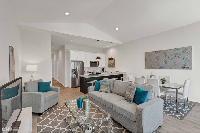 5201 S Wabash Ave, Chicago, IL 60615 - living area featuring light wood finished floors, lofted ceiling, recessed lighting, and baseboards