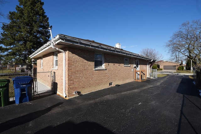 8848 Meade Ave, Oak Lawn, IL 60453 - view of side of home featuring brick siding, a gate, crawl space, and a chimney