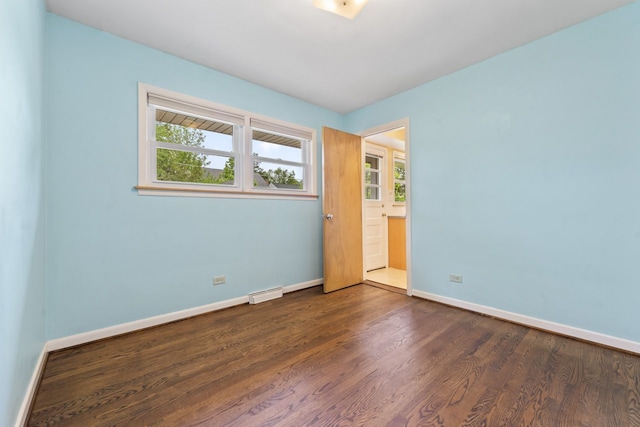 202 N Elmhurst Ave, Mount Prospect, IL 60056 - unfurnished bedroom with dark wood-style flooring, multiple windows, and baseboards