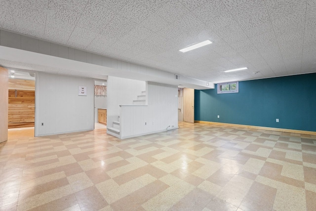 202 N Elmhurst Ave, Mount Prospect, IL 60056 - below grade area featuring light floors, stairs, baseboards, and wood walls
