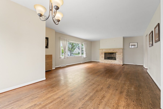 202 N Elmhurst Ave, Mount Prospect, IL 60056 - unfurnished living room featuring wood finished floors, baseboards, a chandelier, and a fireplace