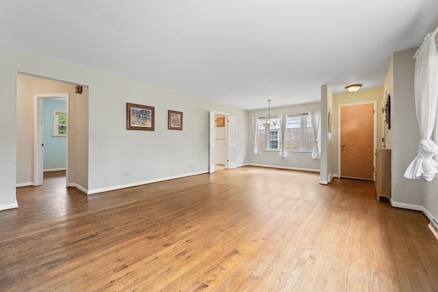 202 N Elmhurst Ave, Mount Prospect, IL 60056 - unfurnished living room featuring a chandelier, wood finished floors, and baseboards