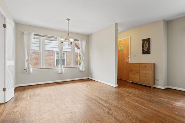 202 N Elmhurst Ave, Mount Prospect, IL 60056 - unfurnished dining area with wood finished floors, a chandelier, and baseboards