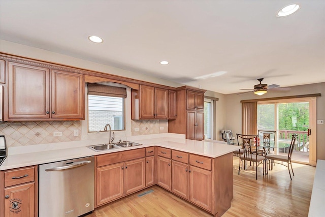 16313 Bob White Cir, Orland Park, IL 60467 - kitchen featuring stainless steel dishwasher, a sink, a peninsula, light wood-style floors, and backsplash
