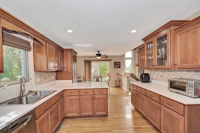 16313 Bob White Cir, Orland Park, IL 60467 - kitchen featuring a sink, dishwasher, a peninsula, light wood-style flooring, and ceiling fan