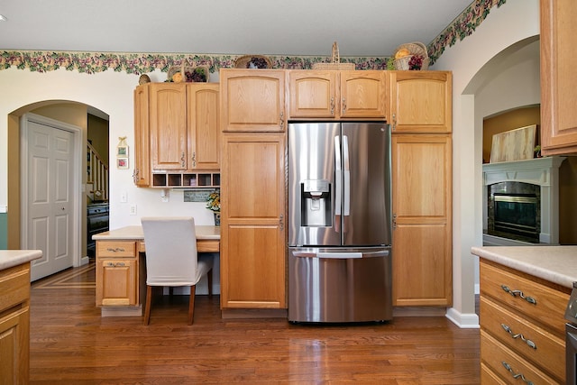 689 Revere St, Bourbonnais, IL 60914 - kitchen with stainless steel refrigerator with ice dispenser, dark wood-style flooring, light countertops, and a fireplace