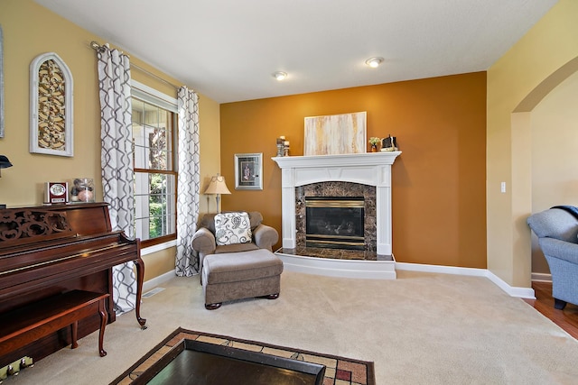 689 Revere St, Bourbonnais, IL 60914 - carpeted living room with arched walkways, a high end fireplace, and baseboards