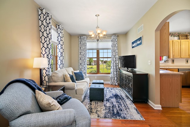689 Revere St, Bourbonnais, IL 60914 - living room with arched walkways, a chandelier, wood finished floors, and baseboards