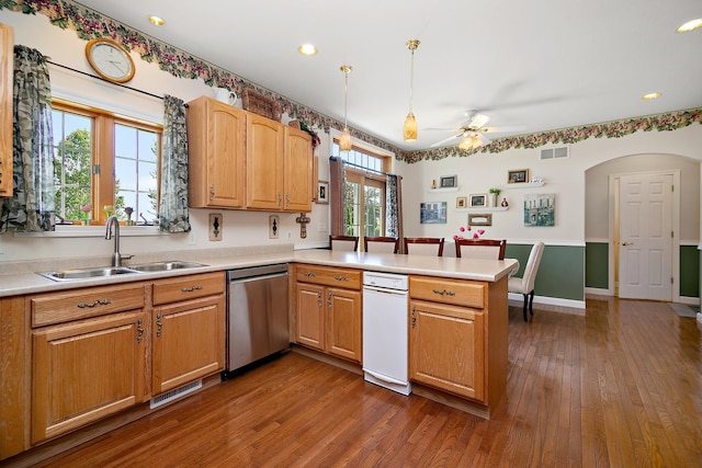 689 Revere St, Bourbonnais, IL 60914 - kitchen with stainless steel dishwasher, a sink, a peninsula, a ceiling fan, and dark wood-type flooring