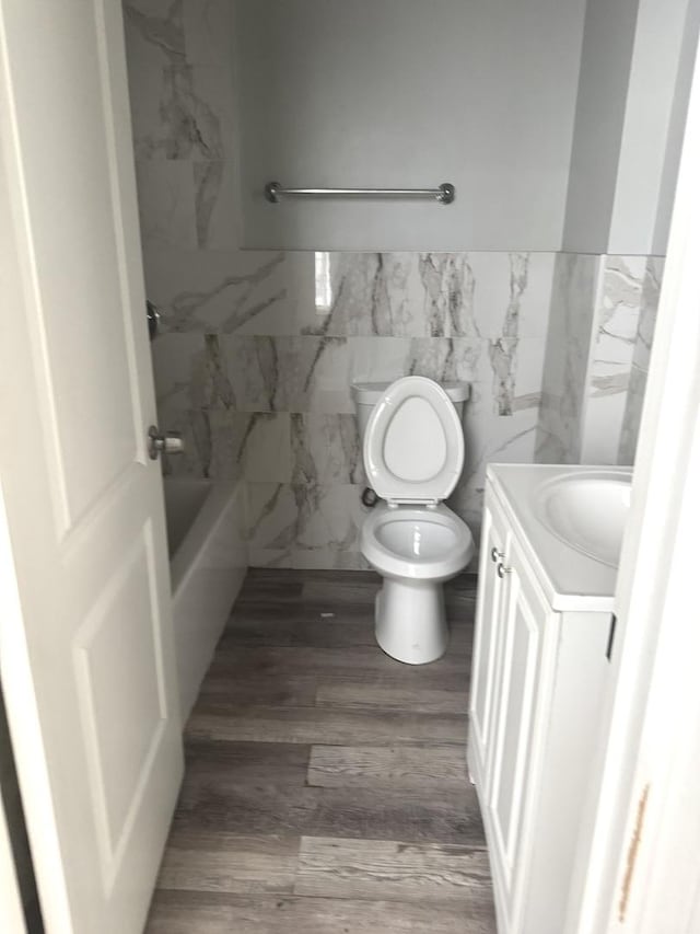 701 E 89th Pl, Chicago, IL 60619 - full bath with toilet, vanity, wood finished floors, wainscoting, and a tub to relax in