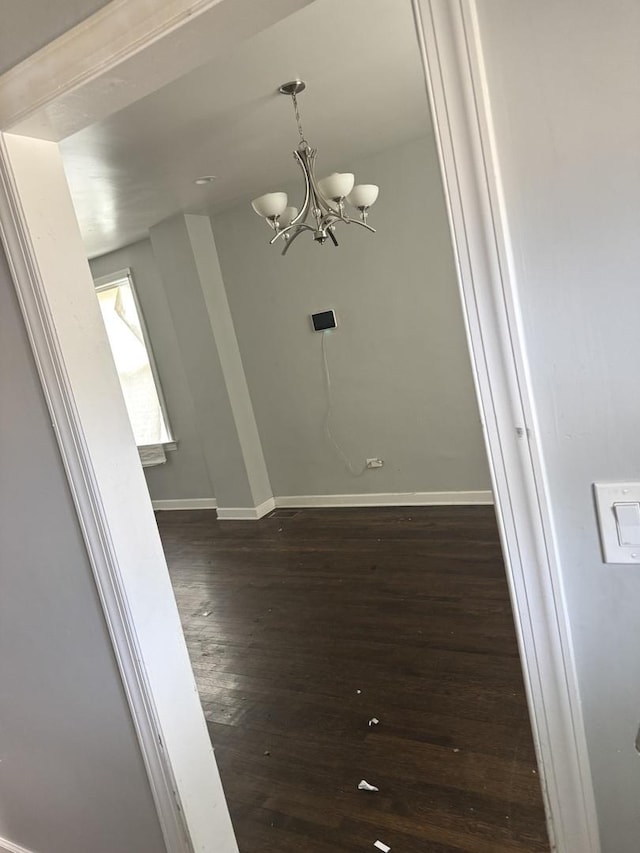 701 E 89th Pl, Chicago, IL 60619 - unfurnished dining area featuring a chandelier, baseboards, and dark wood finished floors
