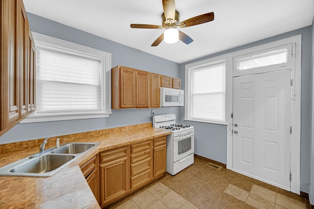 8407 S Throop St, Chicago, IL 60620 - kitchen featuring white appliances, a sink, a ceiling fan, and plenty of natural light