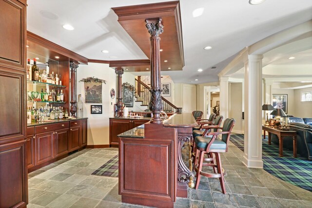 64 Ridge Rd, Barrington Hills, IL 60010 - indoor dry bar featuring decorative columns, baseboards, stairway, recessed lighting, and stone finish floors