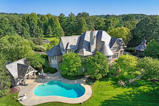 64 Ridge Rd, Barrington Hills, IL 60010 - outdoor pool featuring a lawn, a wooded view, an outdoor structure, and a patio area