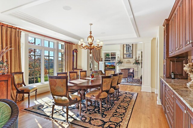 64 Ridge Rd, Barrington Hills, IL 60010 - dining space with a tray ceiling, plenty of natural light, a chandelier, light wood finished floors, and ornamental molding