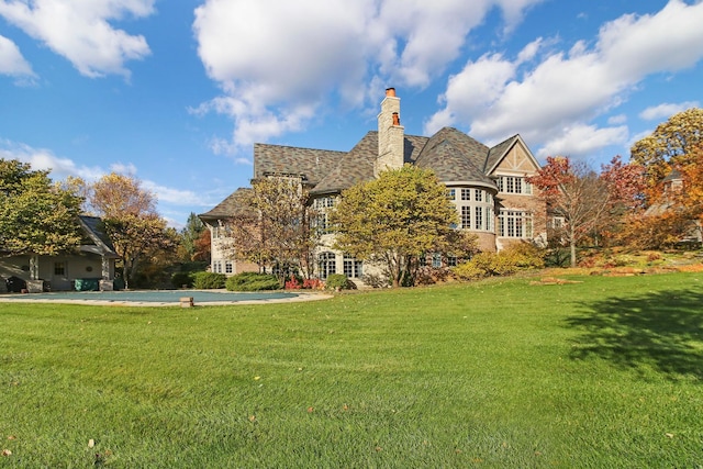 64 Ridge Rd, Barrington Hills, IL 60010 - back of property with a yard, a chimney, and an outdoor pool