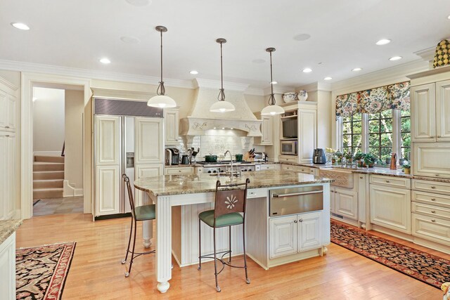 64 Ridge Rd, Barrington Hills, IL 60010 - kitchen with a warming drawer, tasteful backsplash, light wood-type flooring, light stone counters, and ornamental molding