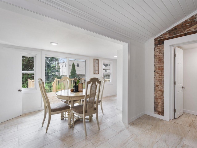 426 Reed St, Pecatonica, IL 61063 - dining room with brick wall, vaulted ceiling, wood ceiling, and baseboards
