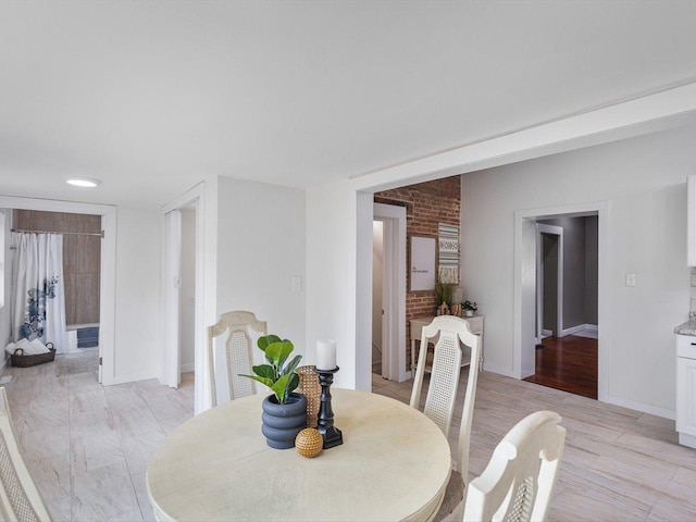 426 Reed St, Pecatonica, IL 61063 - dining area with baseboards and light wood finished floors