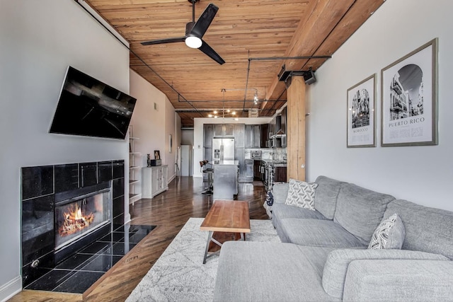2654 W Medill Ave Unit 202, Chicago, IL 60647 - living area featuring wood ceiling, a tile fireplace, dark wood finished floors, a ceiling fan, and rail lighting
