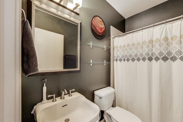 2654 W Medill Ave Unit 202, Chicago, IL 60647 - bathroom featuring a sink, toilet, and curtained shower