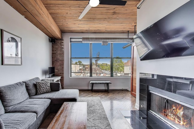 2654 W Medill Ave Unit 202, Chicago, IL 60647 - living area featuring wooden ceiling, ceiling fan, a tiled fireplace, baseboards, and wood finished floors