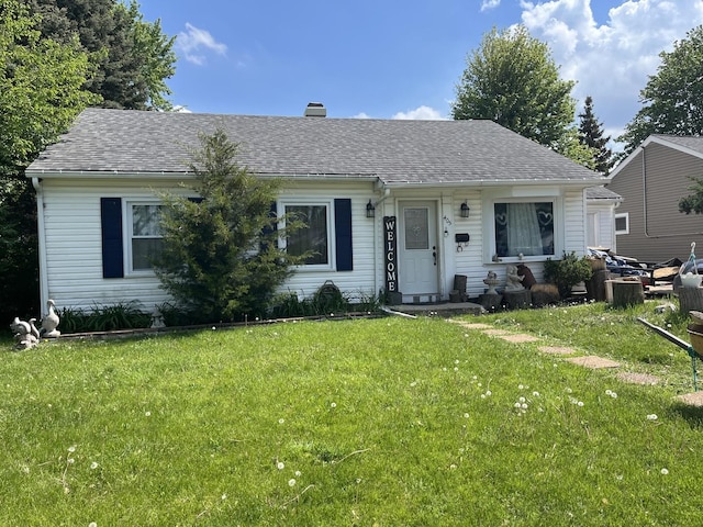 405 Arlington Dr, Romeoville, IL 60446 - view of front of home with a front lawn, a chimney, and roof with shingles