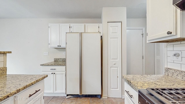 733 Fieldcrest Dr Unit A, South Elgin, IL 60177 - kitchen with white refrigerator, white cabinets, light stone counters, and extractor fan