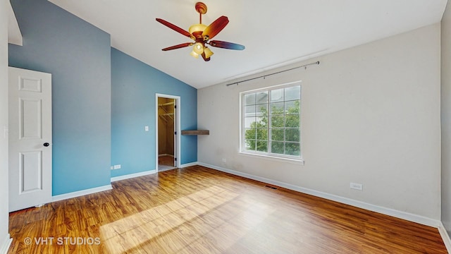 733 Fieldcrest Dr Unit A, South Elgin, IL 60177 - unfurnished bedroom with wood finished floors, baseboards, a closet, a spacious closet, and high vaulted ceiling