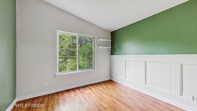 733 Fieldcrest Dr Unit A, South Elgin, IL 60177 - unfurnished room featuring vaulted ceiling, wood finished floors, and baseboards