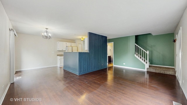 733 Fieldcrest Dr Unit A, South Elgin, IL 60177 - unfurnished living room with a chandelier, dark wood-style flooring, baseboards, and stairway
