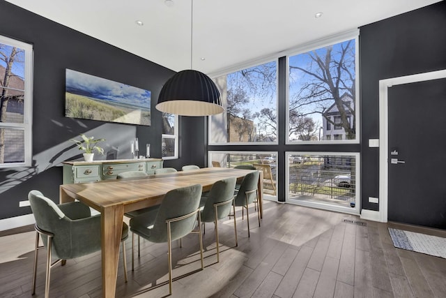 3056 N Monticello Ave, Chicago, IL 60618 - dining room with baseboards, wood finished floors, expansive windows, and recessed lighting