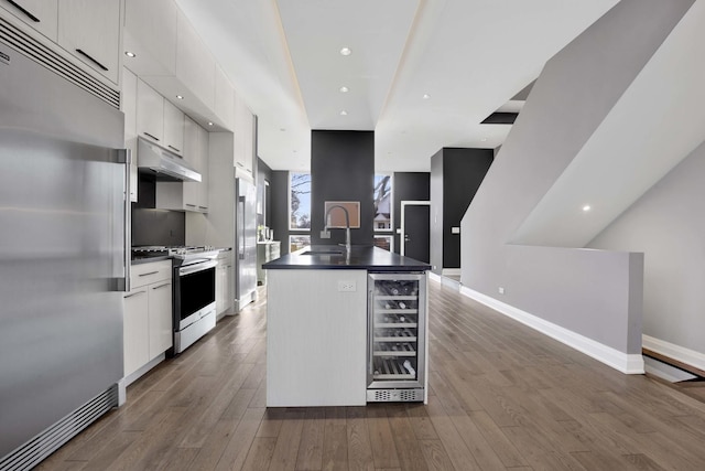 3056 N Monticello Ave, Chicago, IL 60618 - kitchen featuring stainless steel appliances, wine cooler, under cabinet range hood, white cabinetry, and recessed lighting