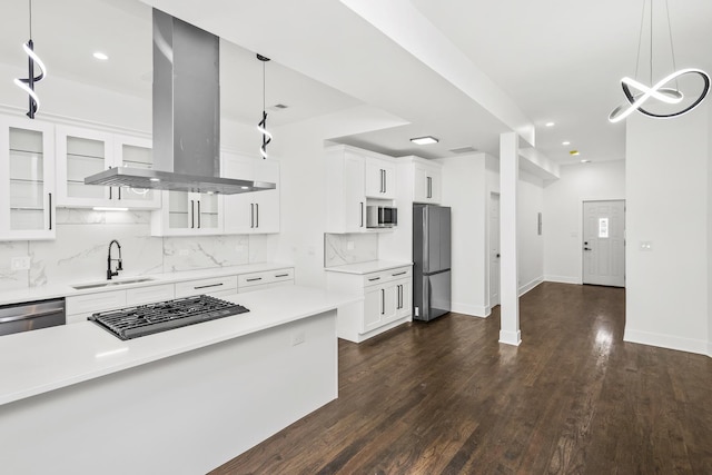 6610 S Saint Lawrence Ave, Chicago, IL 60637 - kitchen with island range hood, stainless steel appliances, a sink, light countertops, and backsplash