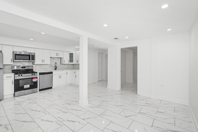 6610 S Saint Lawrence Ave, Chicago, IL 60637 - kitchen featuring stainless steel appliances, light countertops, light marble finish floors, recessed lighting, and backsplash