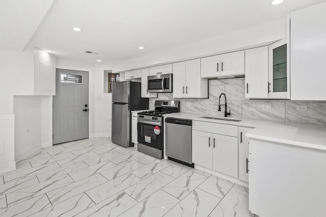 6610 S Saint Lawrence Ave, Chicago, IL 60637 - kitchen featuring appliances with stainless steel finishes, a sink, recessed lighting, white cabinetry, and baseboards